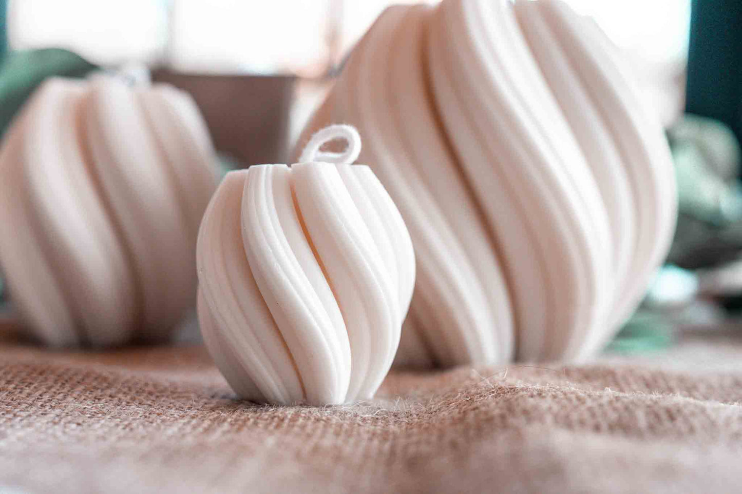 kleine cremeweiße Wellenkerze im Hintergrund weitere Wellenkerzen