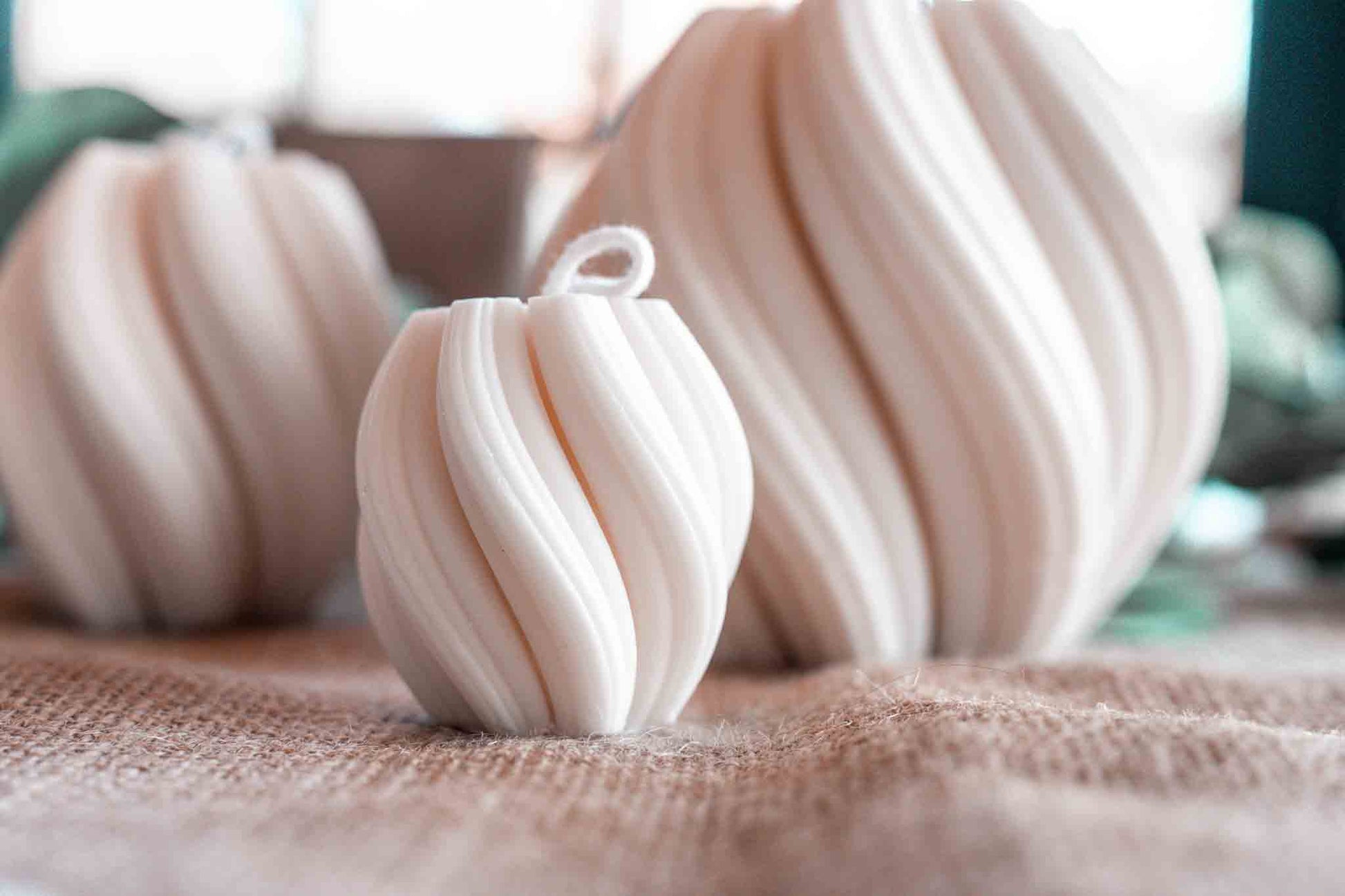 kleine cremeweiße Wellenkerze im Hintergrund weitere Wellenkerzen